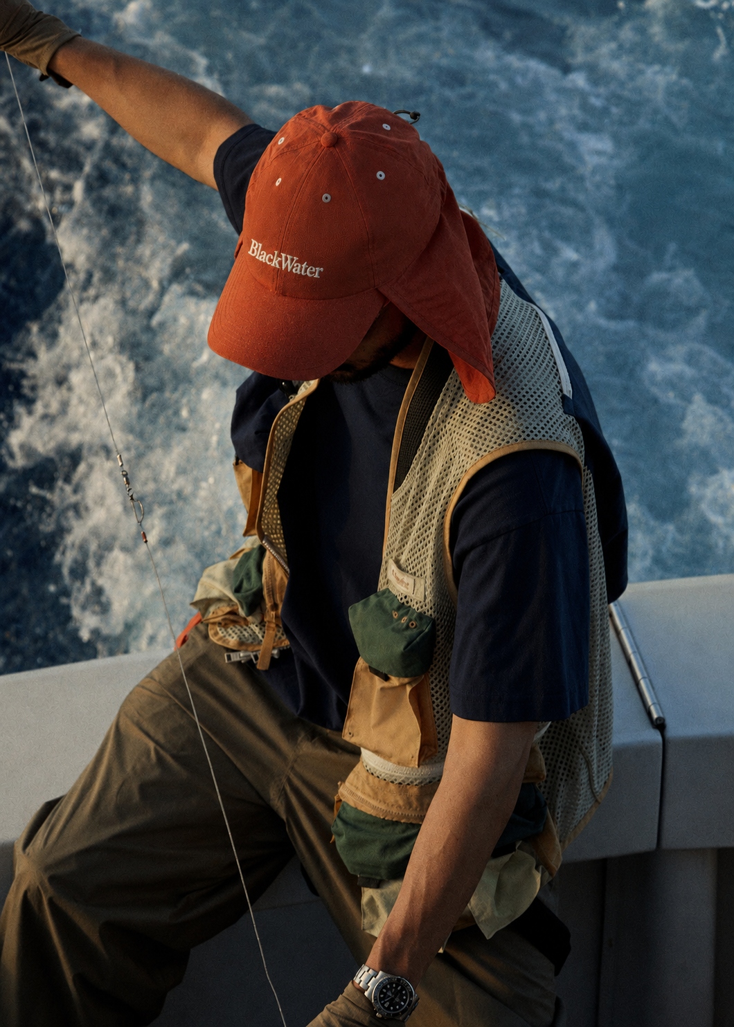 Angler in a BlackWater cap on a boat